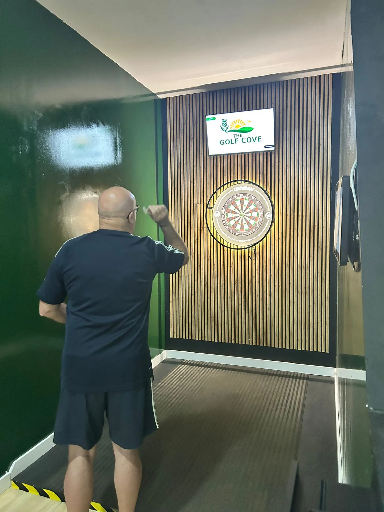 Group playing digital darts with automatic scoring at The Golf Cove, Fuerteventura