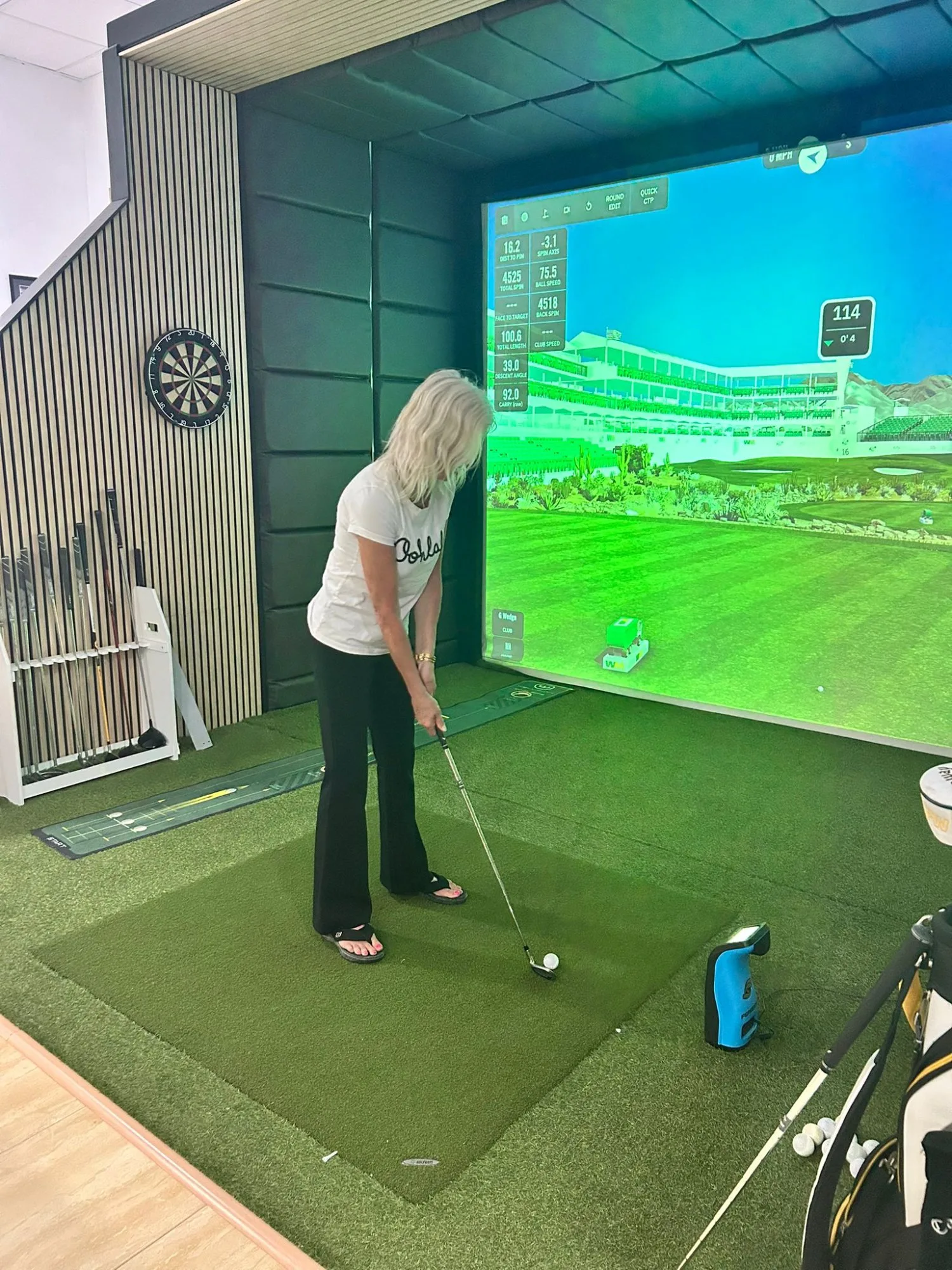 Golf shot analysis screen showing carry distance and spin rate at The Golf Cove